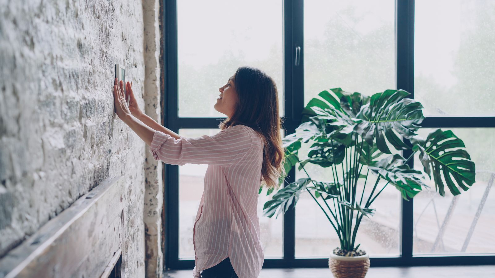 A smart thermostat mounted on a wall in a Florida home